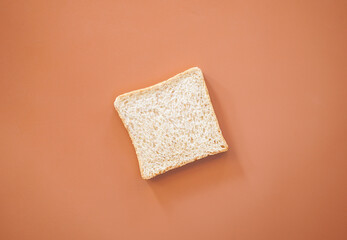 Whole wheat bread on brown background