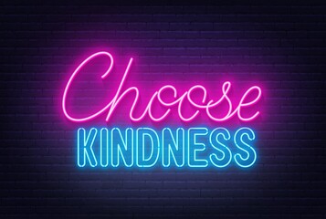 Choose Kindness neon sign on brick wall background.
