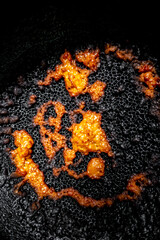 Deep dark abstract yellow-orange burning cream texture. Milk burning pots orange-yellow bubble...