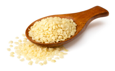 Hulled hemp seeds in the wooden spoon, isolated on the white background.