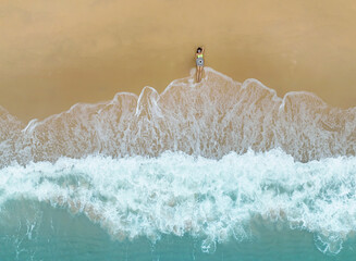 Top view of Young woman with arms apart on sand beach and sun tanning relaxing sunbathing on the...