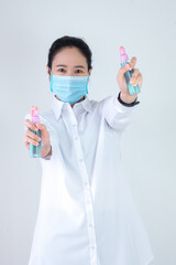 Asian woman are strengthening to overcome the virus by wearing a mask and carrying alcohol bottles for washing hands, cleaning or spraying infected items. Covid-19