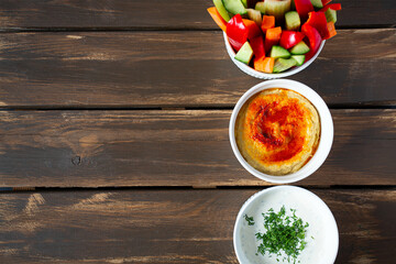 fresh vegetables, saur cream dip and hummus isolated on white