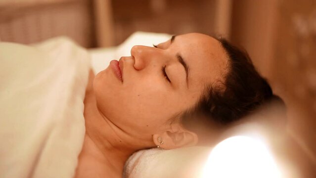 Deep sleeping at soothing luxury spa with candles around