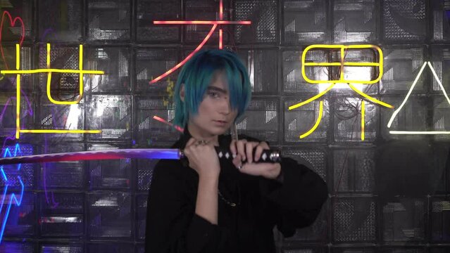 A young man or woman is holding a Japanese katana sword. Modern Samurai. The inscription on the background in Japanese - Let from darkness to light
