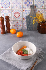 Fresh tomato salad, stracciatella and pesto sauce