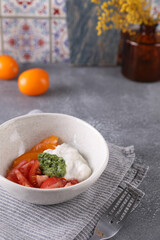 Fresh tomato salad, stracciatella and pesto sauce