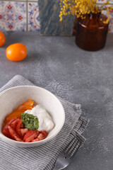 Fresh tomato salad, stracciatella and pesto sauce