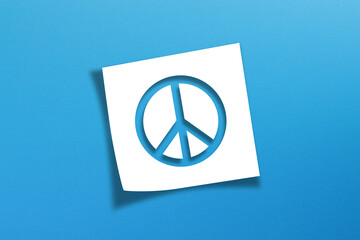 Peace symbol with note paper isolated on blue background