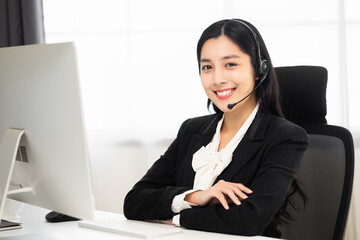 Call centre female operator. Smiling asian business woman receptionist wearing headphone video conference calling talk by webcam in online chat customer support service.