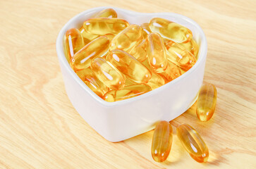 Cod Liver Oil Capsules in white cup.