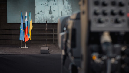 Anti war protest stage between ukraine and russia in slovenia, View from behind the camera towards stage with flags and screen