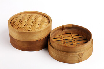 Traditional bamboo basket oriental dimsum steamer with lid and two base, on white background photo.