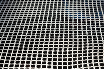 White mesh on black. Cellular grid of white color on a black background.