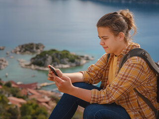 Fototapeta na wymiar Travel and tourist attractions at Kekova island, Turkey. Woman traveler explores ruins castle of Simena with view of sea bay and Kekova Island with famous flooded city. Tourist attractions in Turkey.