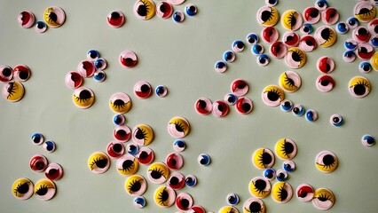 Decorative plastic multi-colored eyes for decorating toys and handmade crafts. Abstract image of eyes looking at you