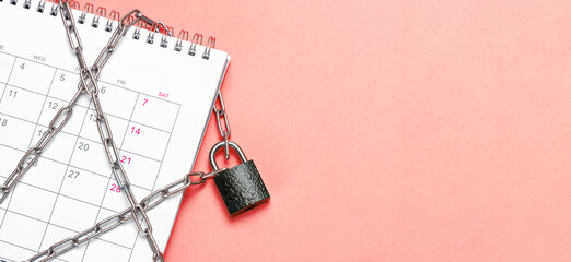 Calendar is wrapped in a chain and closed with a padlock. Red background. Template Copy space for...