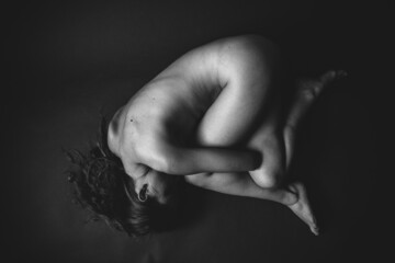 Body details close-up, nude female body. Nude skin photography in black and white. Light defocus...