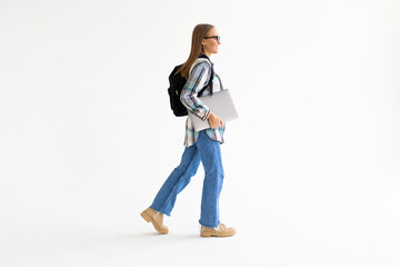 Smiling female student holding laptop and looking at camerisolateda on a white background