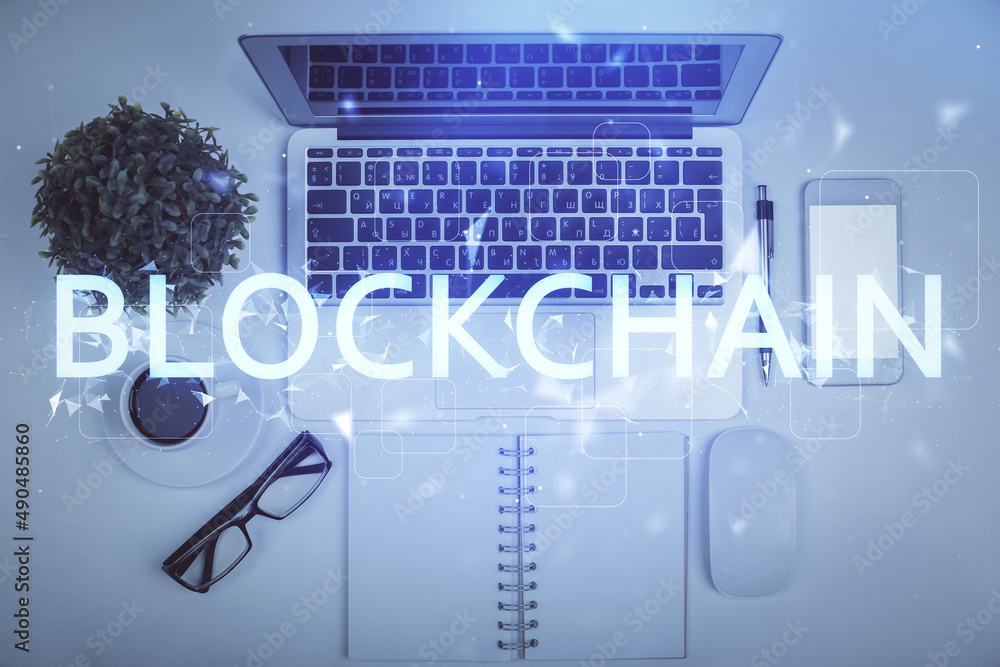 Poster blockchain theme hologram drawings over computer on the desktop background. top view. multi exposure