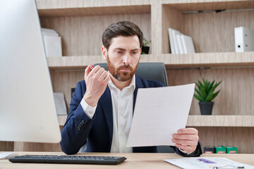 Businessman reading business contract, planning project, working in office, reading resume,...
