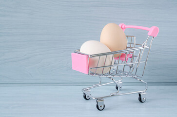 Eggs in a food basket. Rising food prices. Photo with an empty place for an inscription.