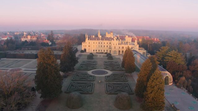 Aerial View Of Lednice Castle, Moravia, Czechia. Famous Tourist Spot. Fairytale Castle In A Baroque Garden, Lit By The Morning Sun. Unesco Cultural Heritage. Winter Season, Moravia, Czech Republic.