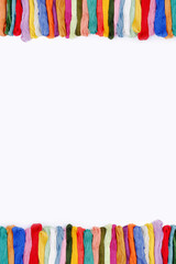 Background of multicolored sewing thread floss for embroidery. Handmade concept, cross-stitch and on a specialized machine for embroidery logos, embroidery on clothes. Copyspace.Vertical photo