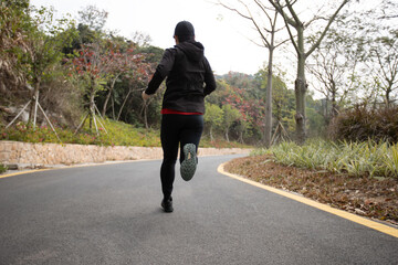 Asian woman jogging in park