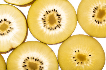 Kiwi Gold fruit background. Yellow kiwi slices with black seeds, closeup