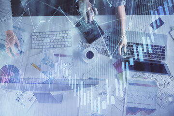 Multi exposure of man and woman working together and financial chart hologram. Business concept. Computer background.