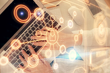Fototapeta premium Double exposure of woman hands working on computer and social network theme hologram drawing. Top View. People connection concept.