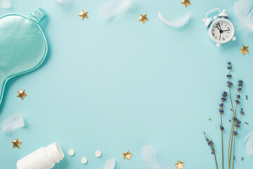 Top view photo of sprig of lavender feathers small white alarm clock blue silk sleeping mask open bottle with pills and golden stars on isolated pastel blue background with copyspace in the middle