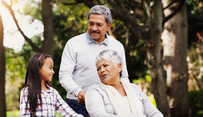 Her stories always have me at the edge of my seat. Shot of an adorable little girl spending some time with her grandparents at the park.