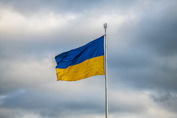 Biggest in Ukraine ukrainian national flag in Kiev on stormy sky background