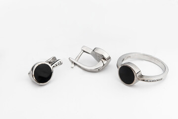 Silver jewelry set of ring and silver earrings with stones on white background. Silver jewelry set collection