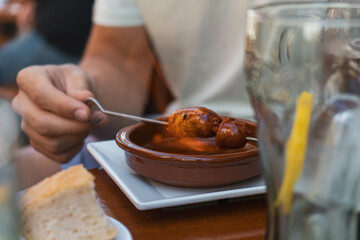 person with chorizo tapas