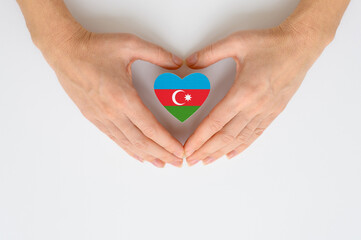 The national flag of Azerbaijan in female hands.