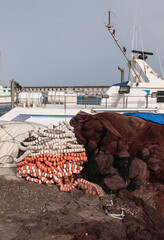 Fishing nets and floats with boat on port. Roquetas del Mar, Almeria, Spain