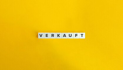 Verkauft (Sold in German) Word on Letter Tiles on Yellow Background. Minimal Aesthetics.