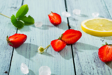 strawberry jam ingredients on blue wooden table