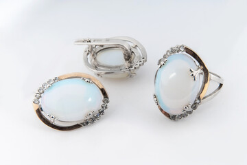 Elegant jewelry set of white gold ring, necklace and earrings with diamonds. Silver jewellery set with gemstones. Product still life concept