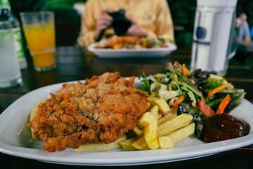 schnitzel and salad in a beer garden