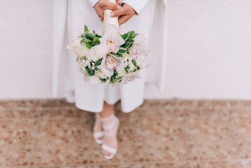 Bride with flower bouquet. Detail of bride holding bridal bouquet.
