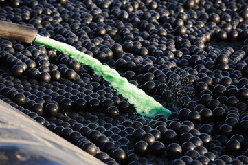 Fototapeta premium East Kazakhstan region, Kazakhstan - 12.02.2015 : The chemical tank is covered with plastic balls to slow evaporation at the copper cathode mining plant.