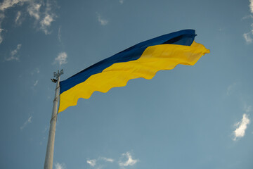 Biggest in Ukraine ukrainian national flag in Kiev on blue sky background, stop russian invasion, freedom and independence in Europe