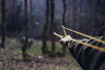 A rock is pulled back in an sling shot pointed 