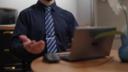 Headless businessman in blue tie with laptop computer gesture with hands explaining