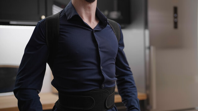 Headless male person in dark blue collar shirt wear posture belt