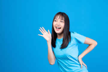 Fototapeta premium Portrait of beautiful young Asian girl model long hair in casual summer clothes smile, happy and enjoying in studio isolated on yellow background.